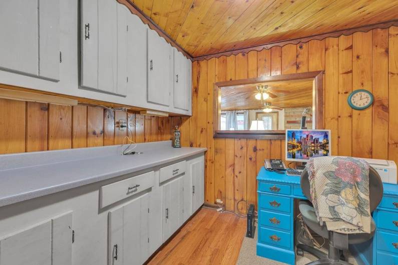 Den makes for a great home office with lots of storage and original hard wood flooring.