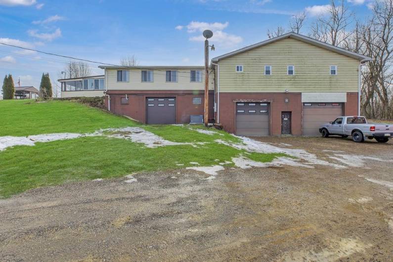 Back of home view shows 3 stall garages.