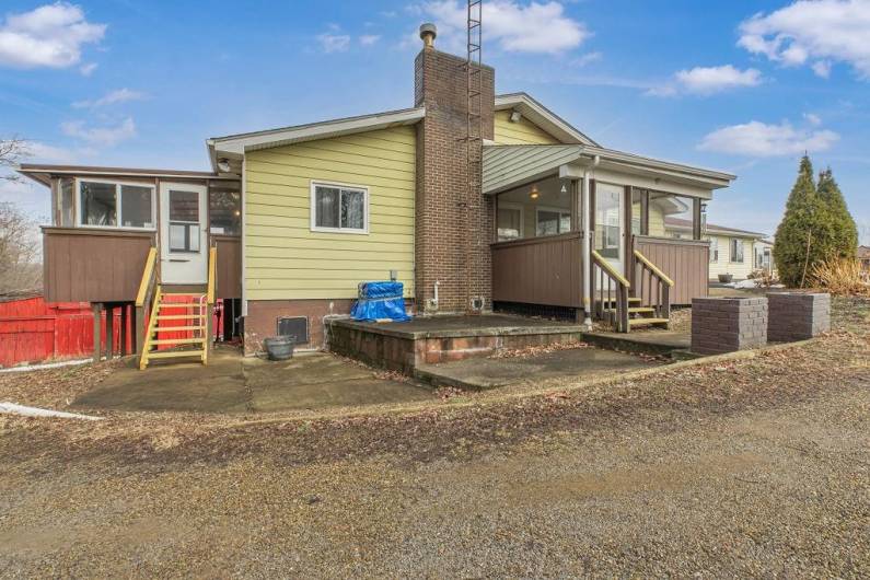 View of main entrance and additional entrance to screened in sun porch and mud room.