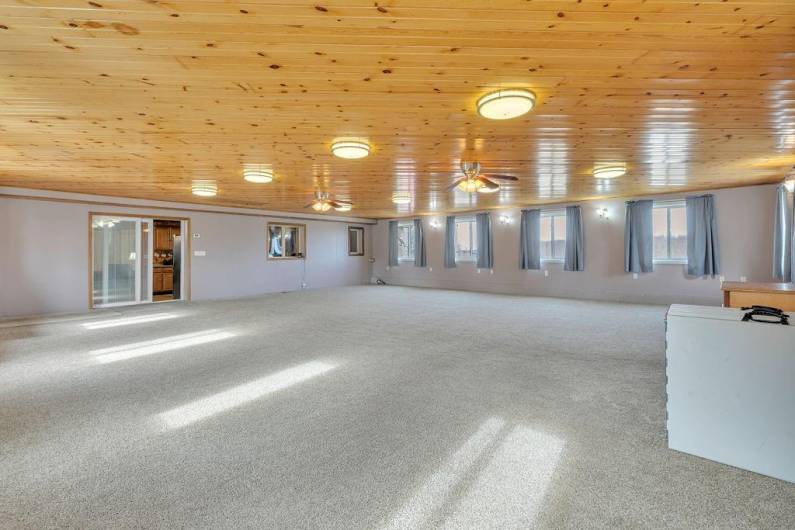 Expansive Family Room for the best of parties. View shows enclosed blinds slider doors to kitchen.