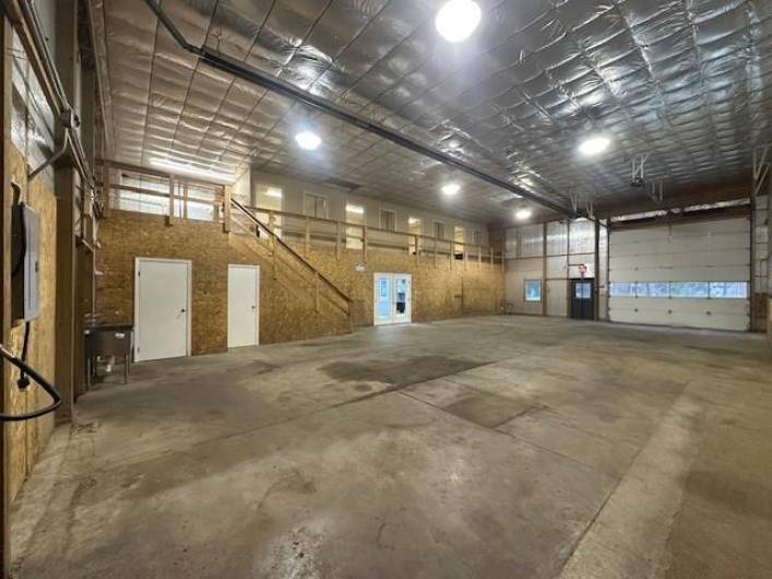 Huge warehouse space with 4 private offices and storage in loft area at top of warehouse stairs.