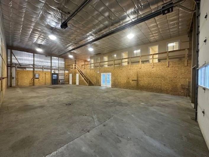 Huge warehouse space with 4 private offices and storage in loft area at top of warehouse stairs.