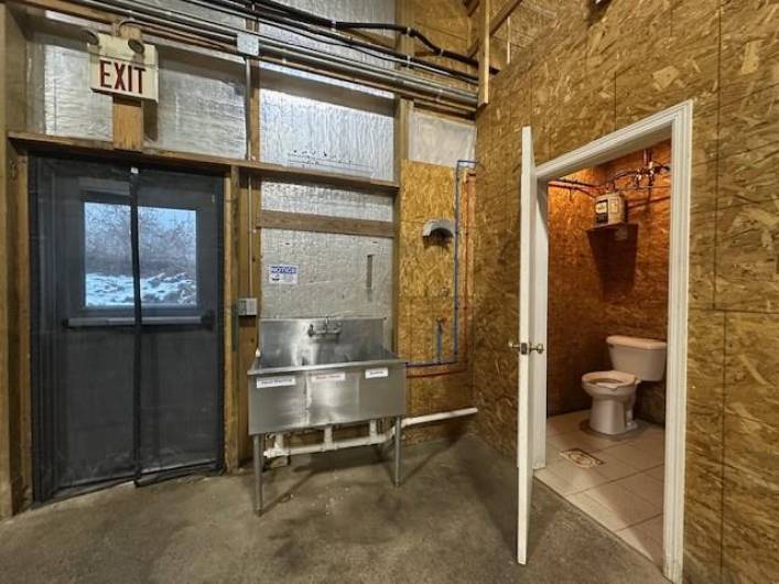 Warehouse bathroom at base of loft stairs