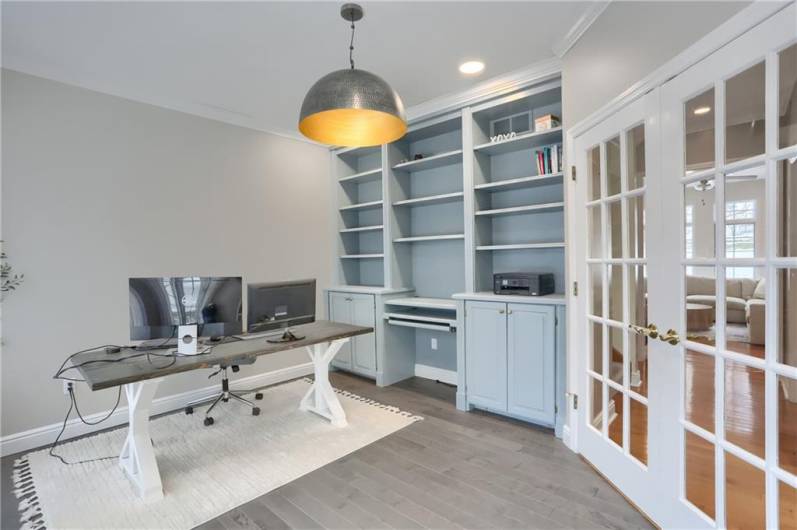 A custom built in bookshelf has been finished with a modern tone that complements the newer flooring.