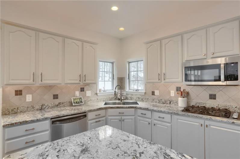 The well lit corner sink provides views of the rear yard.