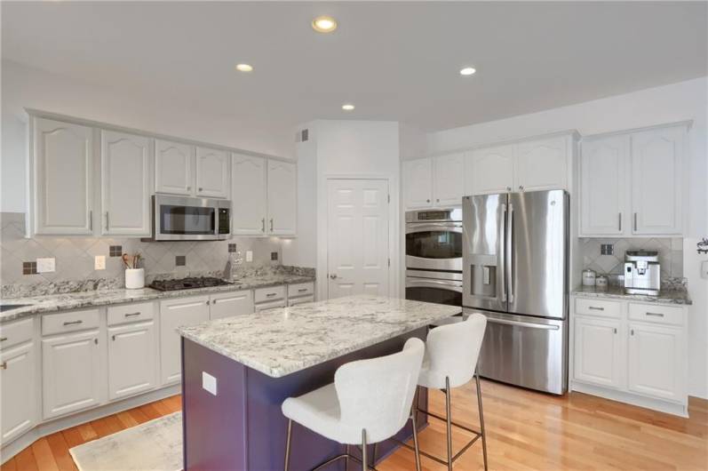 Stainless steel appliances include a gas range, double wall ovens, microwave and refrigerator. A large corner pantry provides abundant storage for all your kitchen needs.