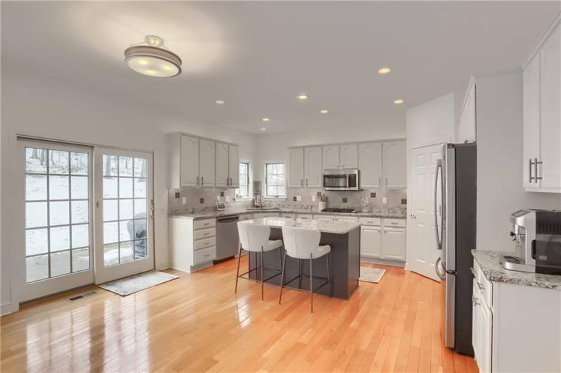 A large sliding glass door provides access to the rear patio and floods the kitchen/eat in dining area with natural light.