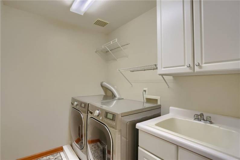 The laundry room has a laundry sink and is provided on the second level making laundry day a bit more convenient.