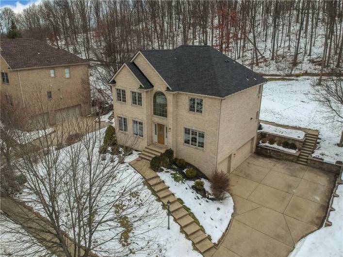 Plenty of parking for guests with a concrete drive that leads to the three car garage.