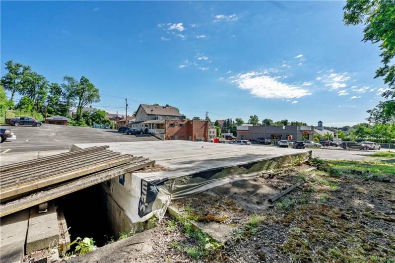 Full foundation (previously ice cream shop) with all utilities and basement (steps are covered with metal planks)