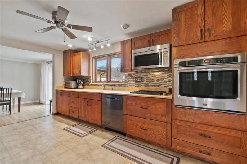 Spacious and updated 16' x 11' kitchen with plenty of counter space for the chef in your family! The kitchen overlooks the private back yard and driveway!