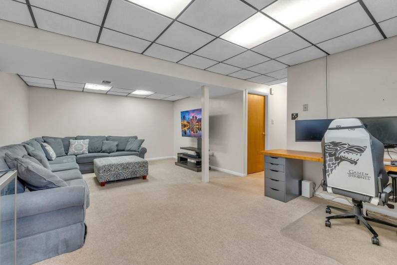 Lower level offers extra space for relaxing, office, or play room.