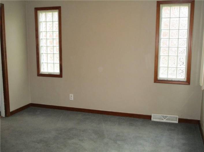 Another view of the dining room with glass block windows for privacy while still letting in an abundance of natural light.