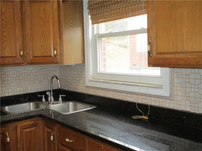 The ceramic tile back splash and corner sinks really adds to the charm of this kitchen.  New dishwasher in 2024 and Gas stove was 2022.