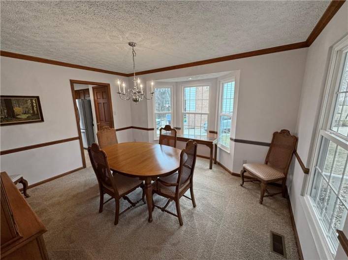 The dining room features a beautiful bay window.