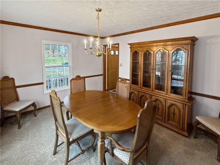 The dining room is also accented with crown and chair rail moldings and features brand new carpeting.