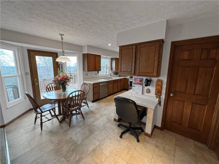 Large kitchen with tons of cabinet space and breakfast area with bay window and door to deck.