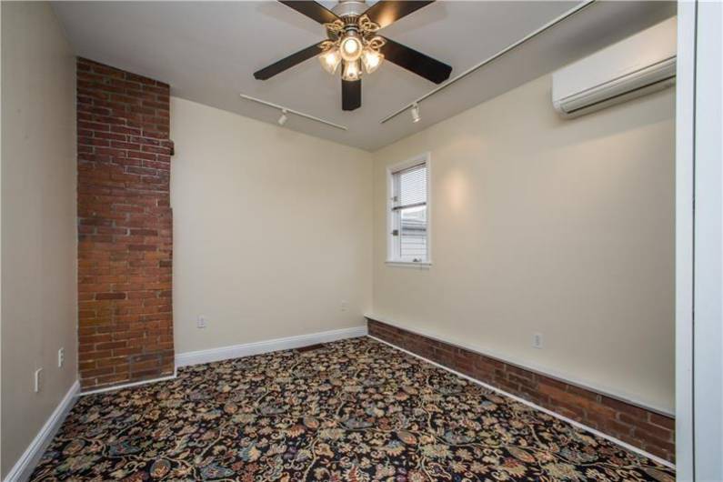 Great bedroom w/ exposed brick accents