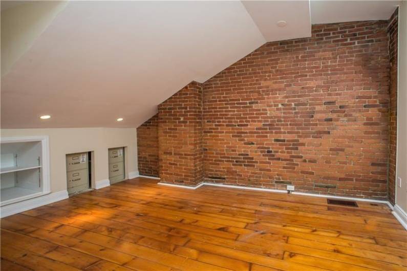 Another great bedroom w/ brick wall, HW floors & built-in desk just beyond the photos range!