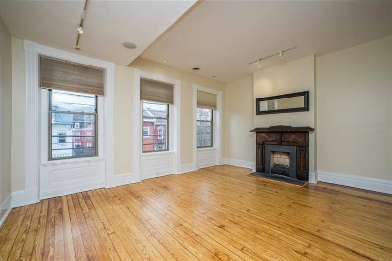 Light filled family room w/ fireplace & HW floors