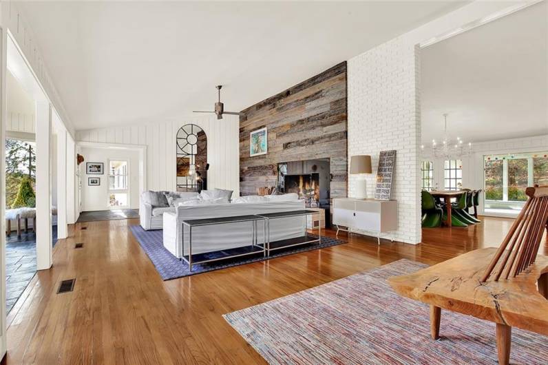 Large living room with cathedral ceiling and hard wood floors