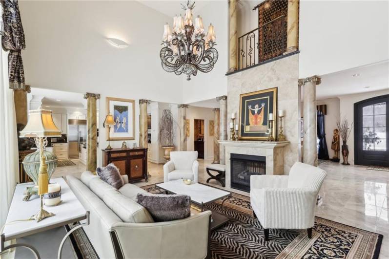 A magnificent chandelier and upper-level Juliette balcony accent the family room.