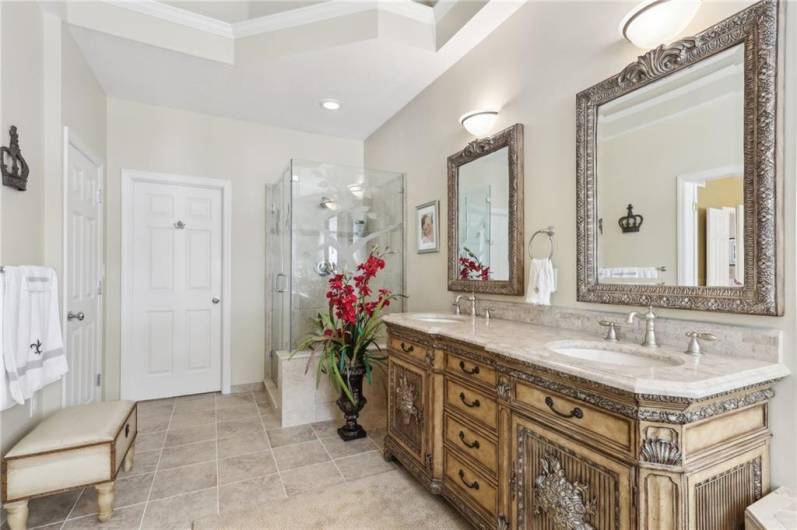 Etched glass enclosed shower, private water closet and walk-in closet.