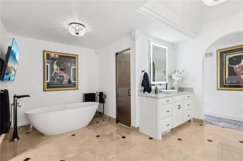 Ornate trey ceiling with crown moldings, private water closet and relaxing soaking tub.