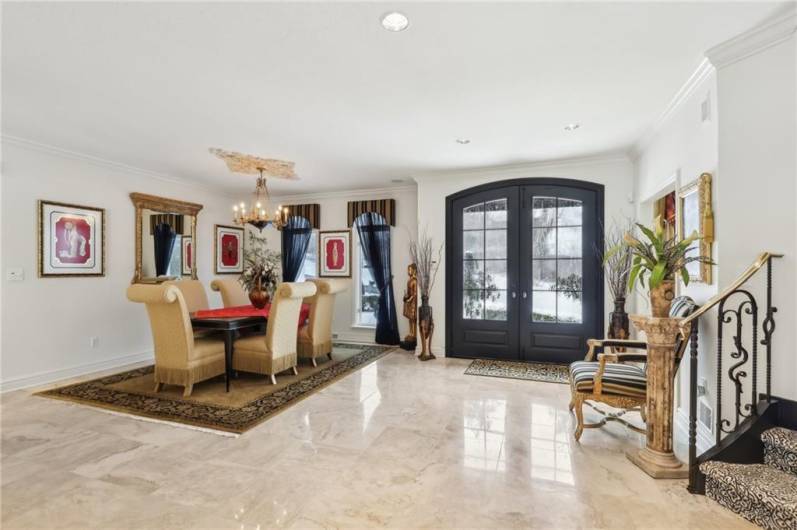 Stately etched glass doors open to the spacious foyer.