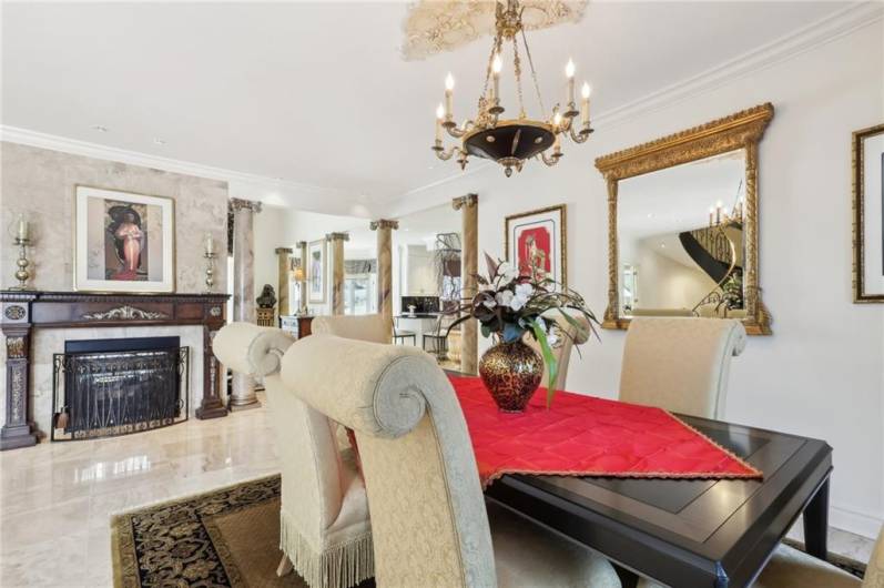 Floor to ceiling windows and impressive gas fireplace with artistic wood mantel