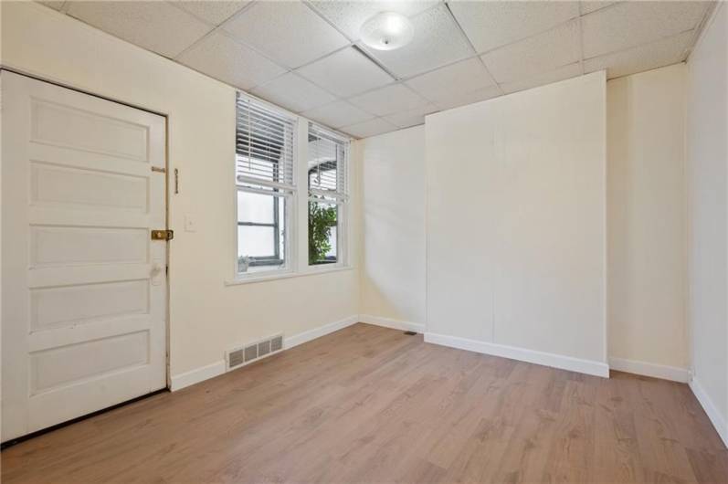 One of the bedrooms in the front of the first floor unit opens to the enclosed front porch. New floor and fresh paint was just done prior to listing.