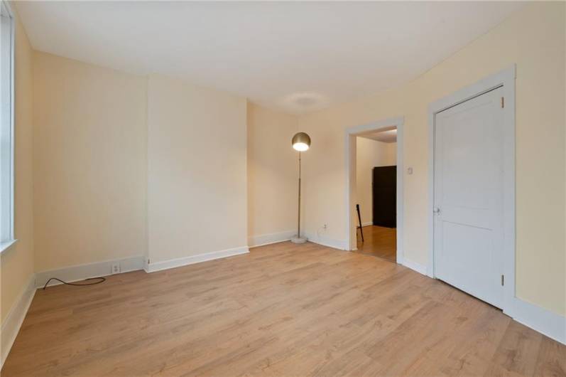 Living room view opening to the kitchen. Fresh paint, great newer flooring.