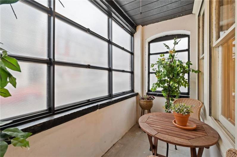 Here is the covered balcony/sunroom. What a cheerful space! New flooring is included in the basement, for your next DIY!