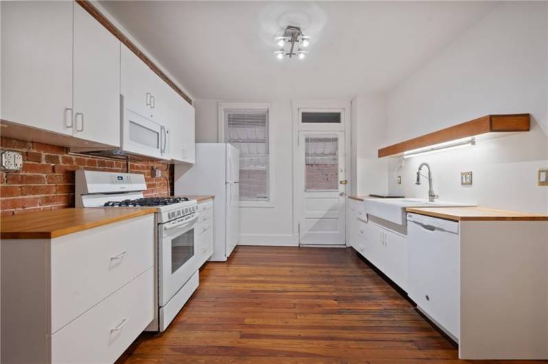 This kitchen was redone after the current owners purchased the home. Lots of cabinets, and access to the back covered porch.