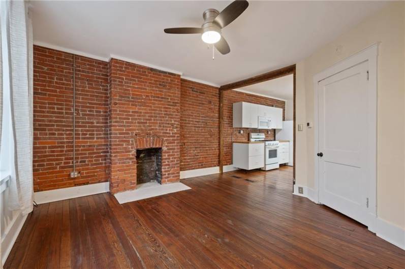 This exposed brick gives a real vibe! The fireplace is decorative, but you could collect some candles inside the hearth for  a beautiful ambiance.