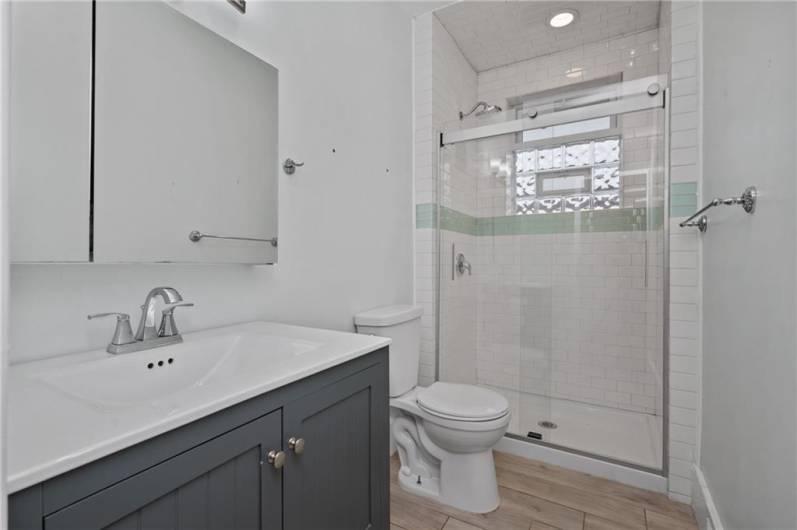 All the work was done for you. This newer bath has a sleek, contemporary look and feel. Again, the bathroom window offers airflow with the vent insert, yet privacy with the glass block. Brilliant!