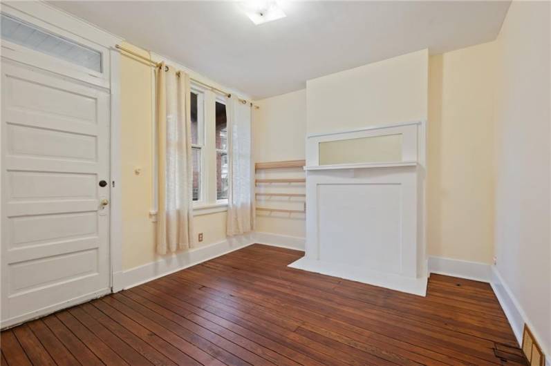 Front Left bedroom with a decorative mantle, hard wood floors, and access to the front, second floor porch.