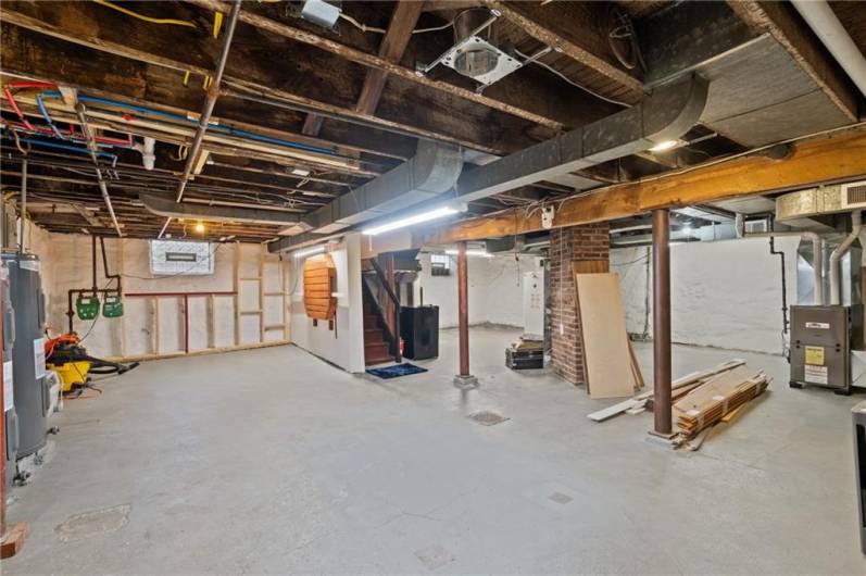 Glass block windows with vents, all electric updated. Water tanks are newer from when the current sellers bought the building. It is a spacious basement, with solid concrete flooring and steel support beams. No knob and tube here!