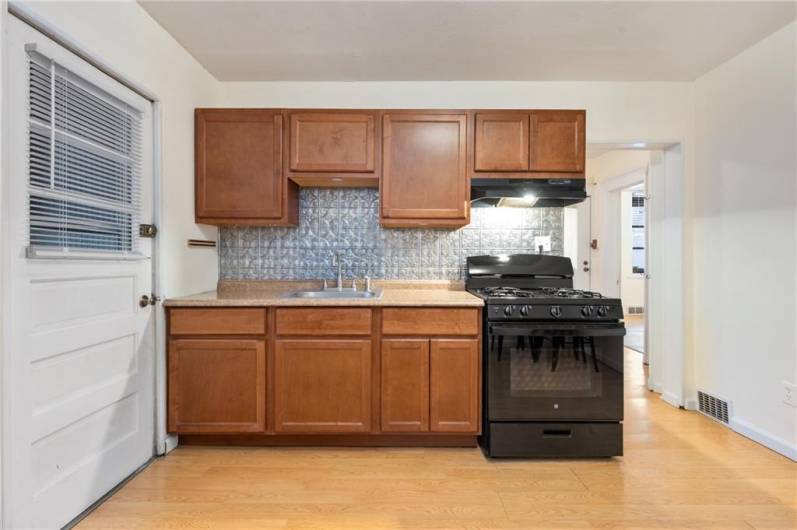 Cabinet run with new gas stove and accent backsplash.