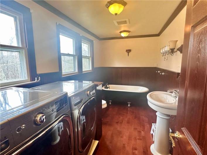 Main level laundry and full bath with soaking tub