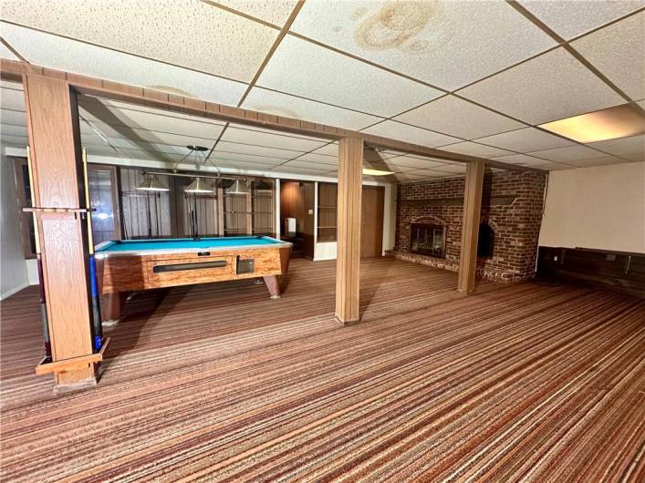 Large game room and fireplace that would be the perfect mancave