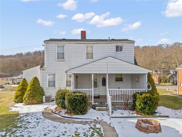 Back of home leading to the fire pit, extra parking, and the shed.