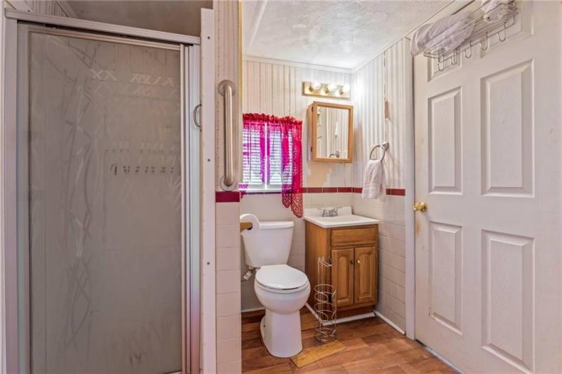 Full main floor bathroom off of the living room, leading to the main floor laundry room.