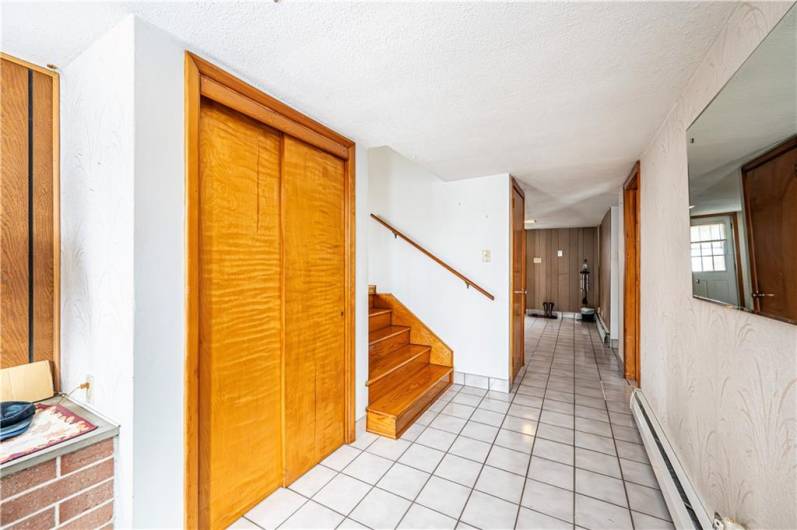 THIS VIEW OF THE ENTRY IS LOOKING TO THE BACK OF THE HOUSE WHERE THERE IS A DOOR TO THE BACK YARD. LET'S WALK UP THE STEPS TO THE LIVING ROOM, DINING ROOM AND KITCHEN