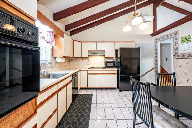 EAT IN KITCHEN ALSO FEATURES THE VAULTED BEAMED CEILING