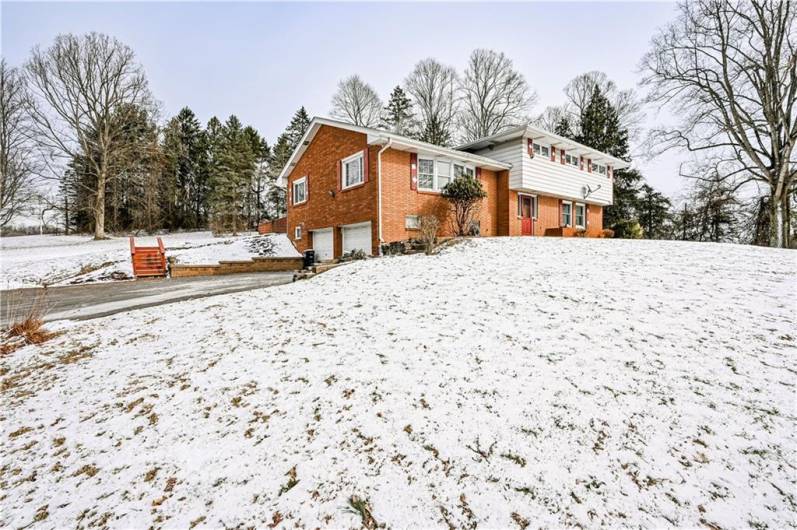 THIS SHOT SHOWS THE INTEGRAL GARAGE AND ACCESS TO THE BACK YARD FROM THE DRIVEWAY