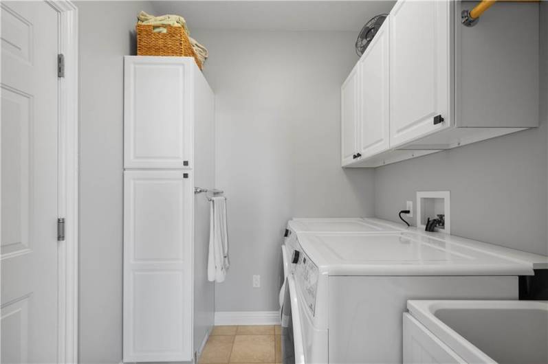 the first floor laundry is very convenient.  There is a utility tub and lots of cabinet storage.  This is plumbed for either a gas or electric dryer.