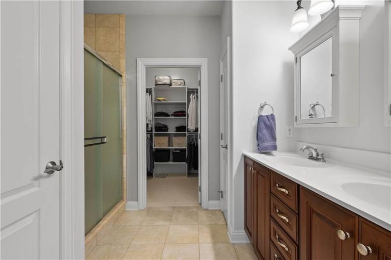 A walk-in closet, double bowl vanity and Tiled shower make up the primary bath.