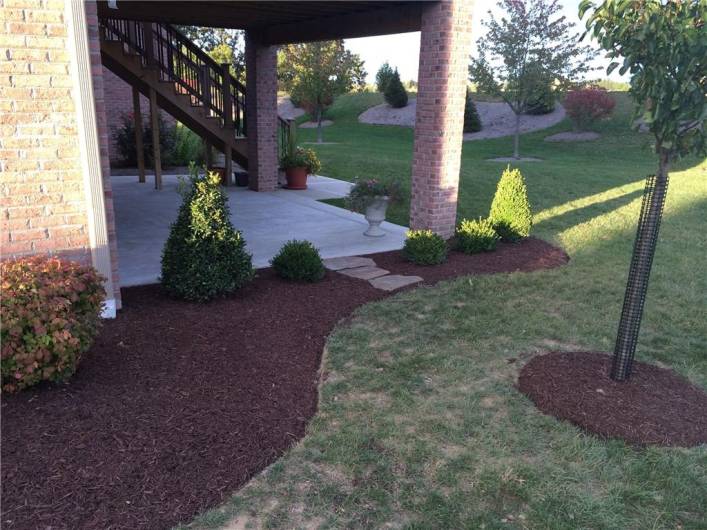 Lovely landscaping around the aggregate patio.