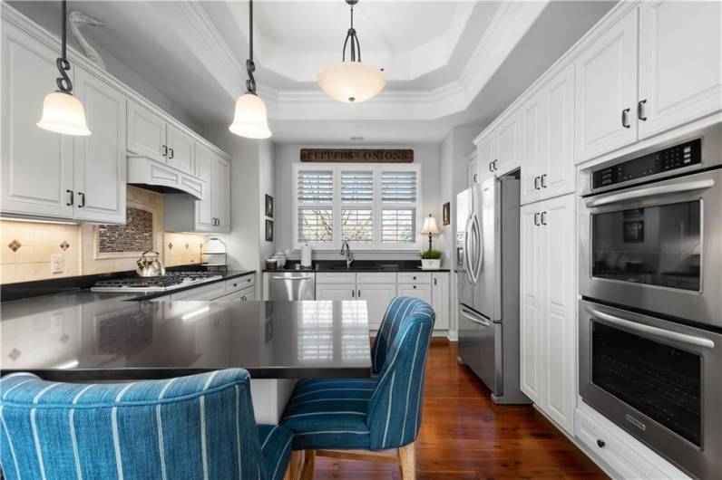 Meal preparation is easy in this light bright kitchen with stainless appliances featuring a 5 burner gas cooktop and double oven - the top is convection.